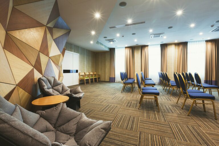 Modern hotel lobby with abstract wooden wall